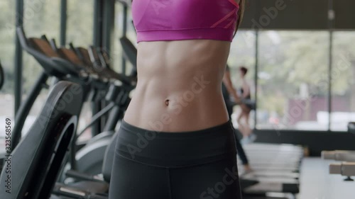 Close- up a six-pack at the belly. sports woman preparing  for a workout in the  Fitness,  Women stretching arms, Concept exercise wellness and  build muscular