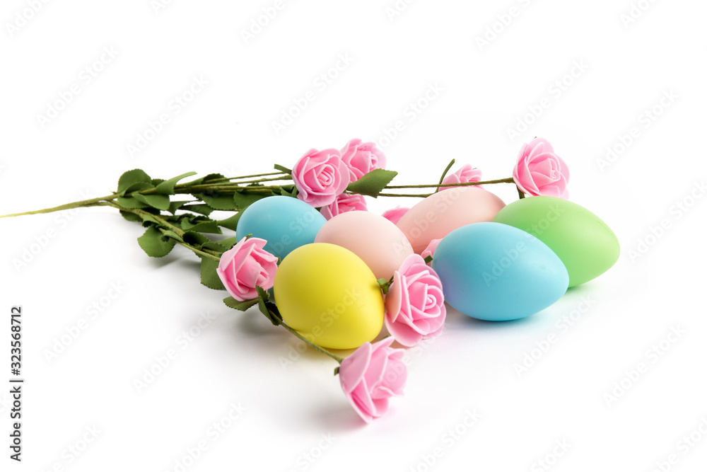 various sizes of Easter eggs with foliage isolated on white