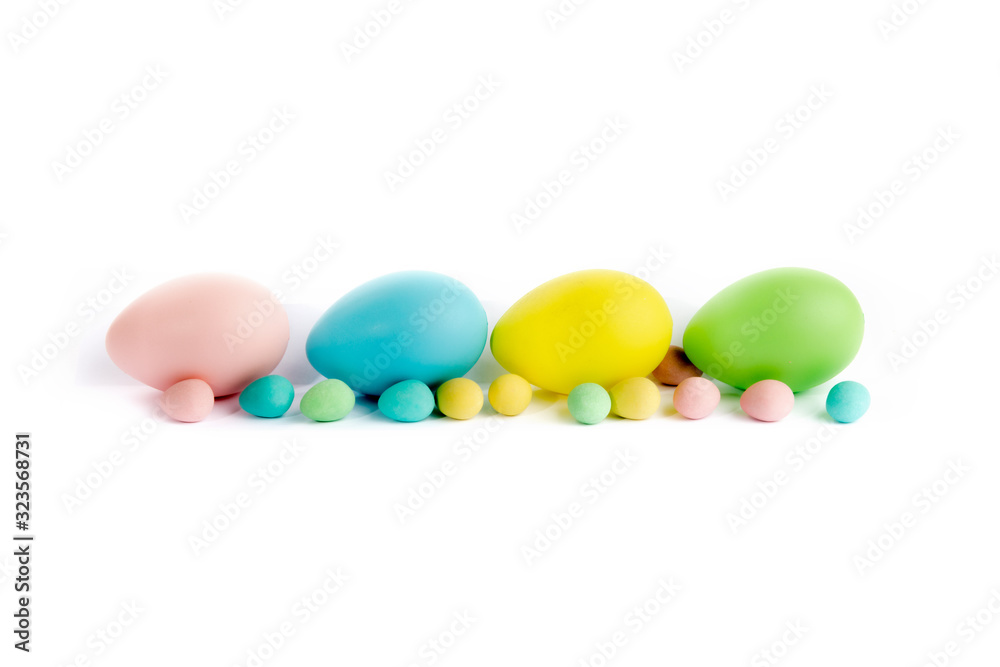 various sizes of Easter eggs with foliage isolated on white various sizes of Easter eggs with foliage isolated on white