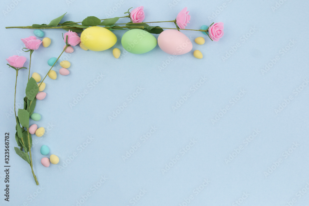 small and large Easter eggs as a border on a background with copy space