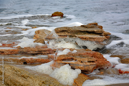 Waves and sea form over coquina rock near Marineland, Florida photo