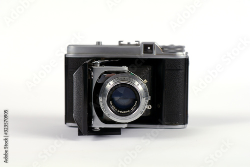 Antique film camera on a white background with pop out lens
