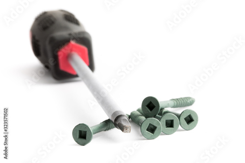 a close up of a square drive robertson style screwdriver and square drive socket wood screws that go together isolated on white photo
