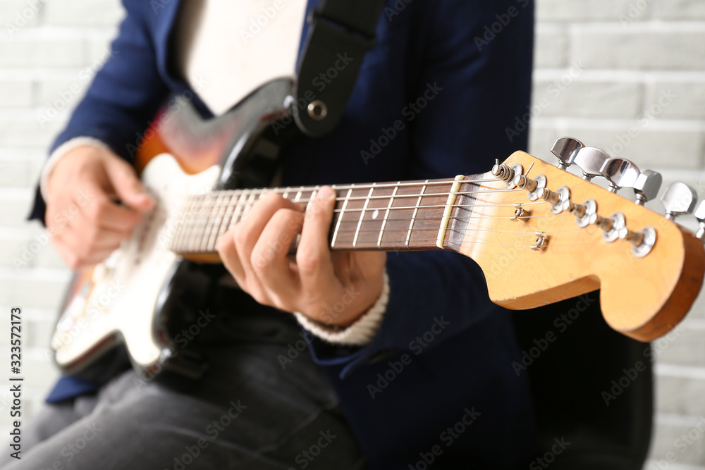 Man playing modern guitar, closeup