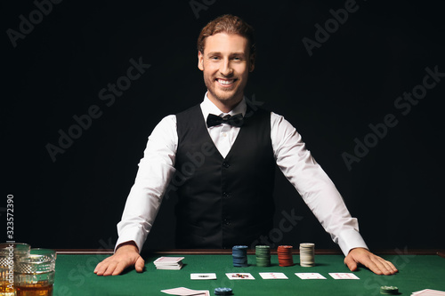 Young male banker at table in casino photo