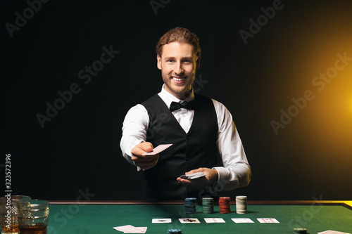 Young male banker at table in casino photo
