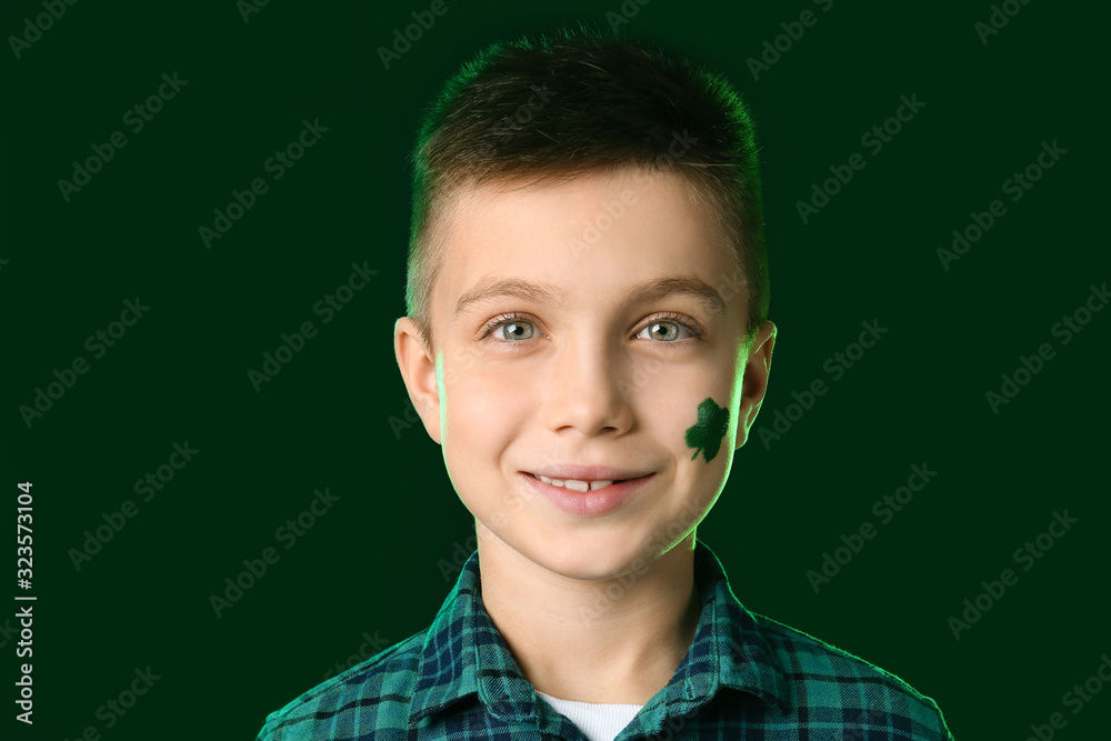 Funny little boy on dark background. St. Patrick's Day celebration Funny little boy on dark background. St. Patrick's Day celebration