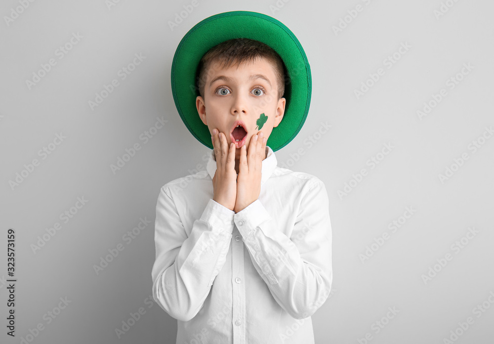 Surprised little boy on white background. St. Patrick's Day celebration