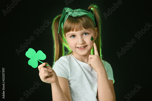 Funny little girl with clov...