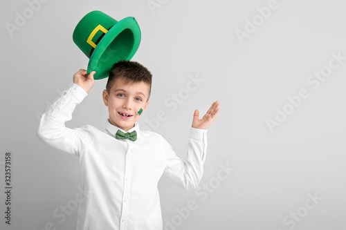 Funny little boy on white b...