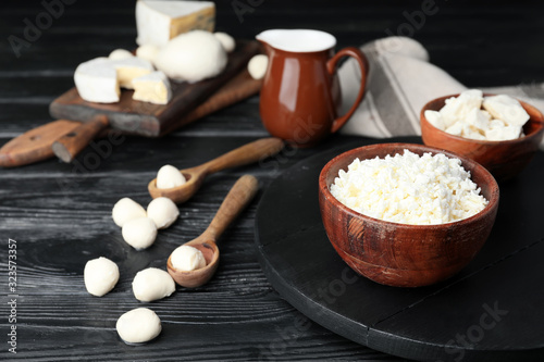 Different dairy products on dark wooden background