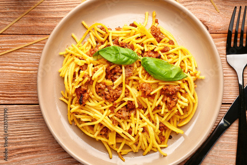 Plate with tasty pasta bolognese on table