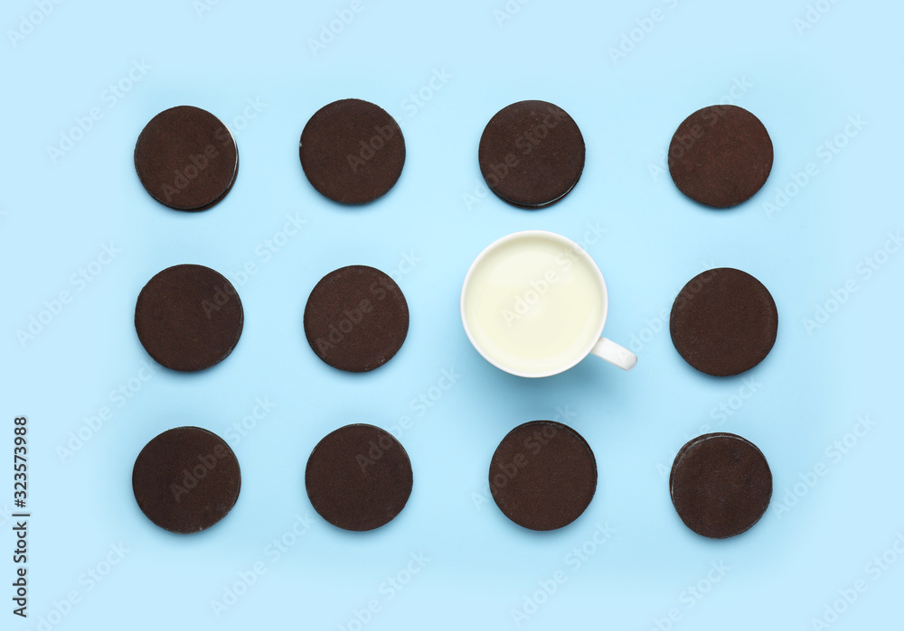 Tasty chocolate cookies with cup of milk on color background