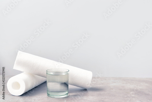 Glass of clean water and filters on table