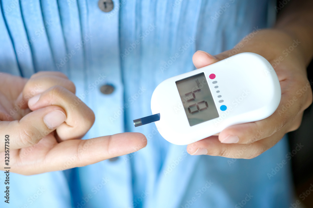 hand of people check diabetes and high blood glucose monitor with digital pressure gauge. Healthcare and Medical concept hand of people check diabetes and high blood glucose monitor with digital pressure gauge. Healthcare and Medical concept