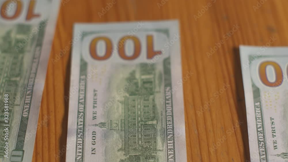 Man pays in cash one hundred dollar bills. Dollars money cash banknotes on table. Money profit calculation. Home economy finance. Personal budget. American currency business. Cash money payment. Man pays in cash one hundred dollar bills. Dollars money cash banknotes on table. Money profit calculation. Home economy finance. Personal budget. American currency business. Cash money payment.
