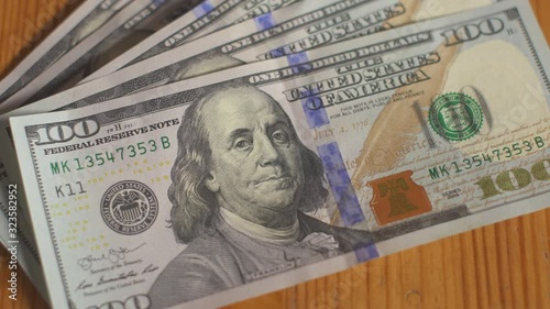 Man throws cash one hundred dollar bills on table. Businessman hold dollars money cash banknotes in hands. Money profit calculation. Home economy finance. Personal budget. American currency business.