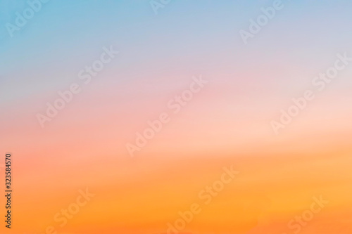 clear sky with a smooth orange-blue gradient. Sunset © andRiU