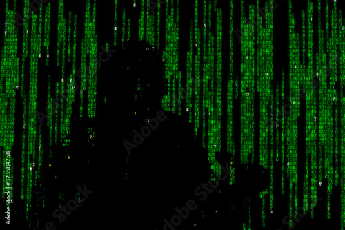 Silhouette of man in green digital data. The symbol of a hacker.