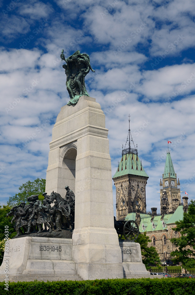 National War Memorial in Confederation Square in Ottawa with Parliament Buildings
