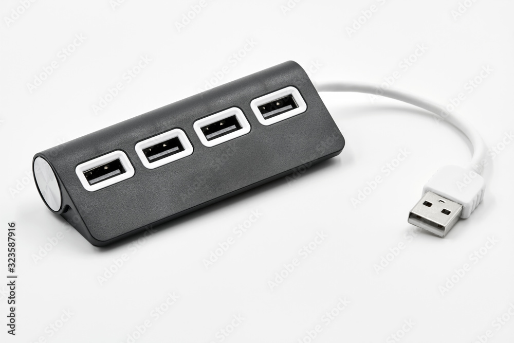 Black portable USB hub for four connections on a white background. Bus povered. Black portable USB hub for four connections on a white background. Bus povered.