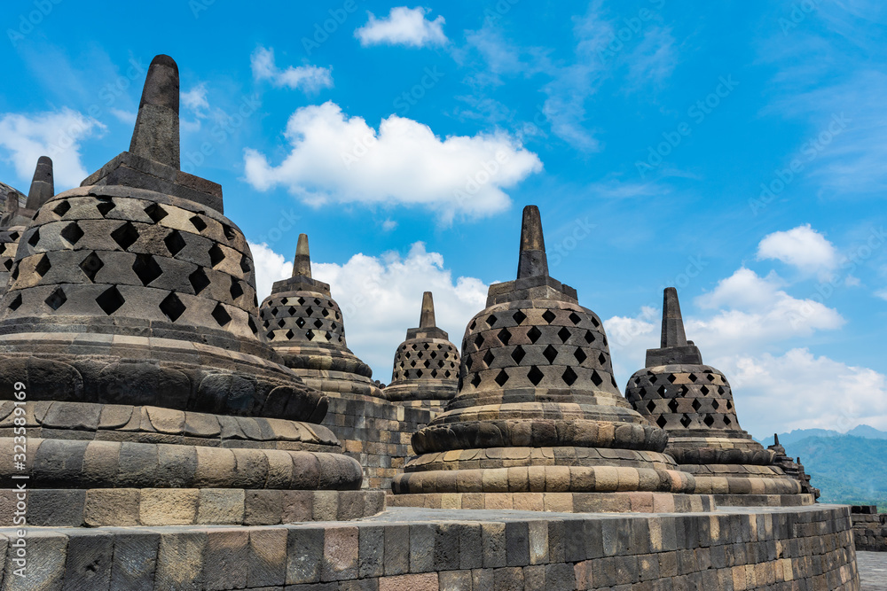 Some stupas in Borobudur Temple, Magelang, Indonesia; with rural Central Java hilly scenery in the background. Borobudur Temple will be the location to celebrate Vesak Day in Indonesia.