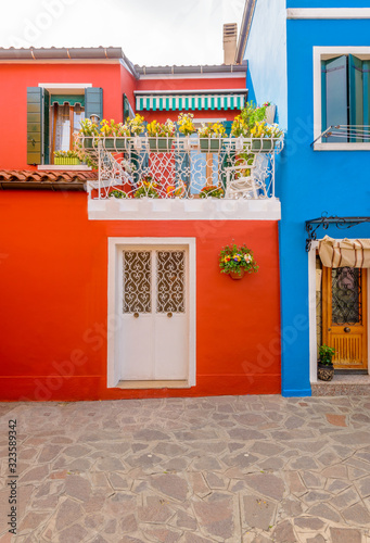 Entrance of a colorful apartment building in Burano, Venice, Italy.