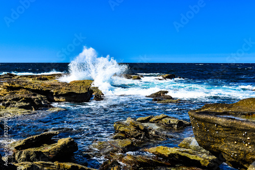 Natures natural beauty, waves crashing on the rocks creating huge sprays of fresh sea water. photo