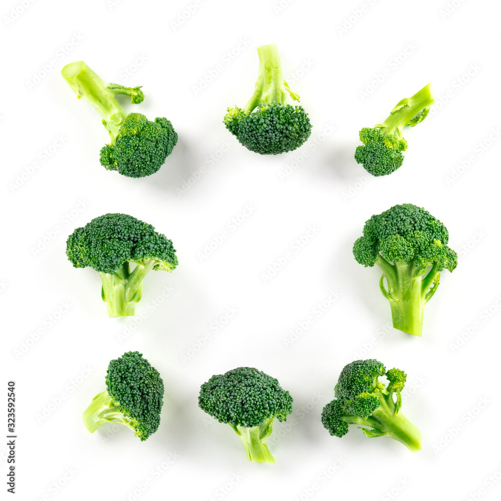 Broccoli florets, shot from above on a white background, forming a square frame with copy space Broccoli florets, shot from above on a white background, forming a square frame with copy space