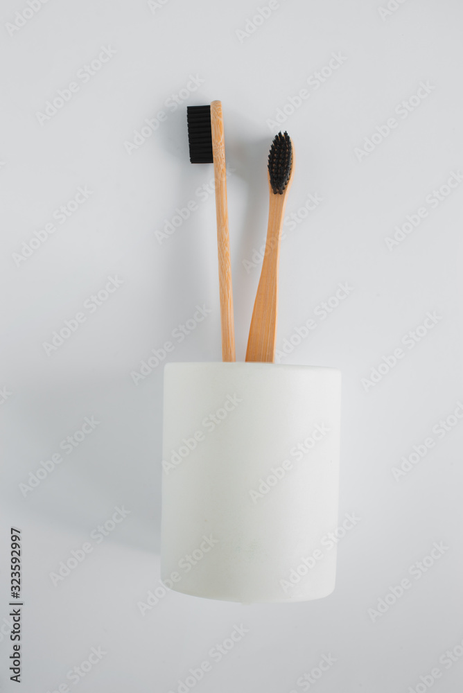 Naklejka premium Natural eco bamboo toothbrush in stand on white background top view