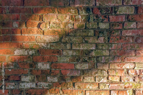 old red brick wall covered with whitewash