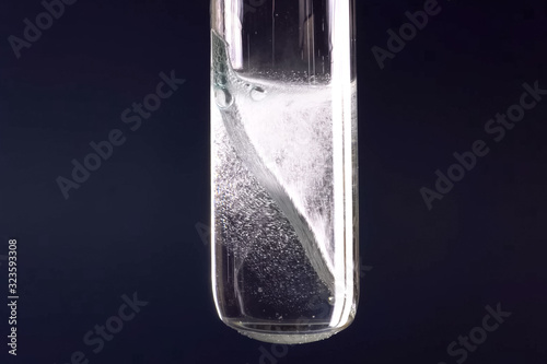 Laboratory flask with a tungsten plate in alkali