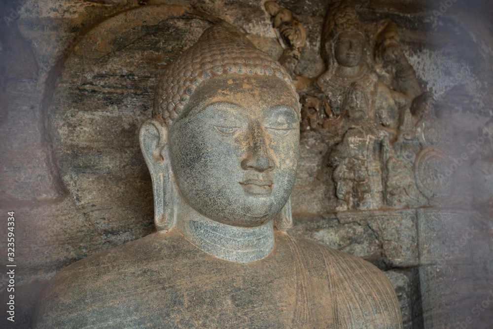 Beautiful face of small Buddha statue located inside the artificial cave named the 