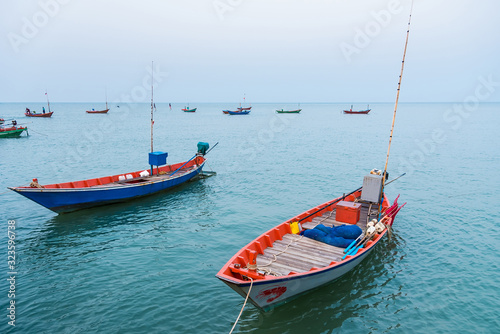 Floating fishing boats aground at the harbor over cloudy sky at Chanthaburi, Thailand.