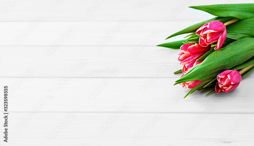 beautiful spring tulip bouquet on a white wooden background. Copy space for text. soft focus, natural sunlight.