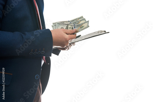businessman signs purchase or lease agreement, holding dollars on isolated white background.