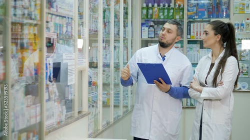 Two young promoters makes a reconciliation of drugs in a pharmacy