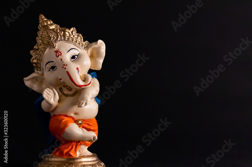 beautiful photography of ganesha statue in front of black background. wisdom concept