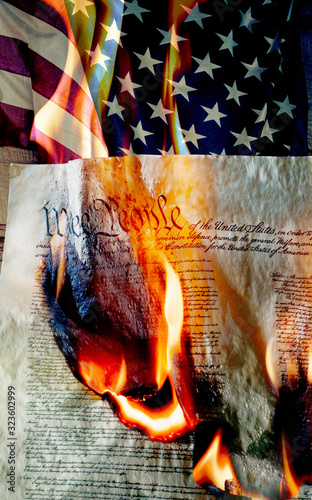 American flag with burning constition