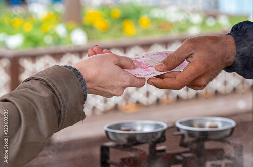 Woman Hand holds Turkish Lira 10 paper Money to pay for Street Food in Istanbul 
