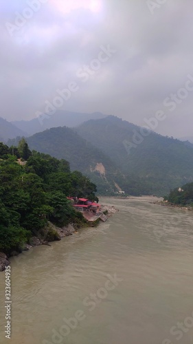 View of the Gangaes with trees, sand and blue sky Shivpuri Rishikesh