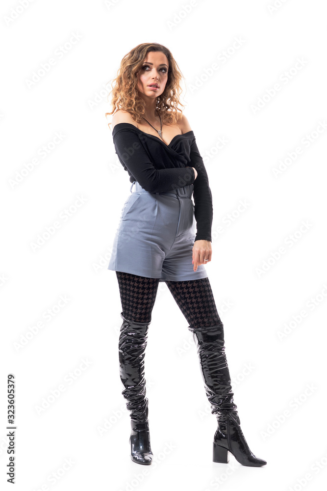 Elegant trendy young curly hair beautiful woman looking up contemplating in glamour clothes. Full body isolated on white background. Elegant trendy young curly hair beautiful woman looking up contemplating in glamour clothes. Full body isolated on white background.