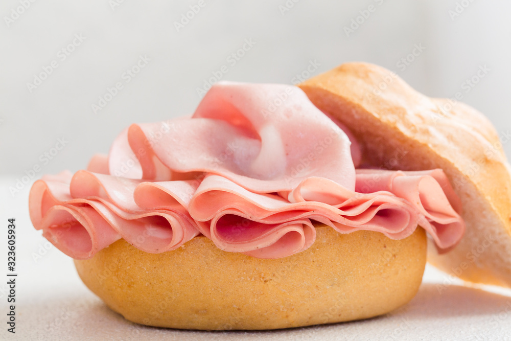 Sandwich with mortadella. Sliced mortadella from Bologna a large