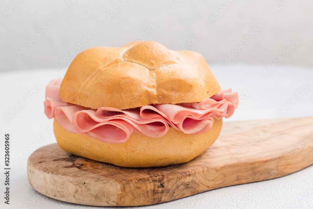 Sandwich with mortadella. Sliced mortadella from Bologna a large