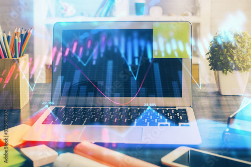 Financial graph colorful drawing and table with computer on background. Double exposure. Concept of international markets. © peshkova