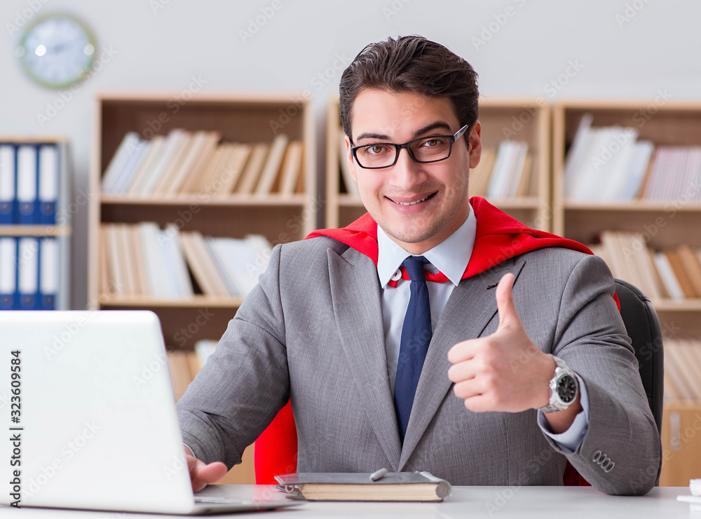 Superhero businessman working in the office Superhero businessman working in the office