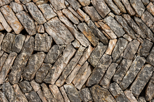 Closeup of a typical dry herringbone stone wall, Veneto region, Italy, Europe 