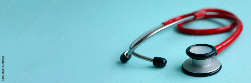 Red doctor stethoscope on blue modern background close-up. Medical insurance concept Red doctor stethoscope on blue modern background close-up. Medical insurance concept