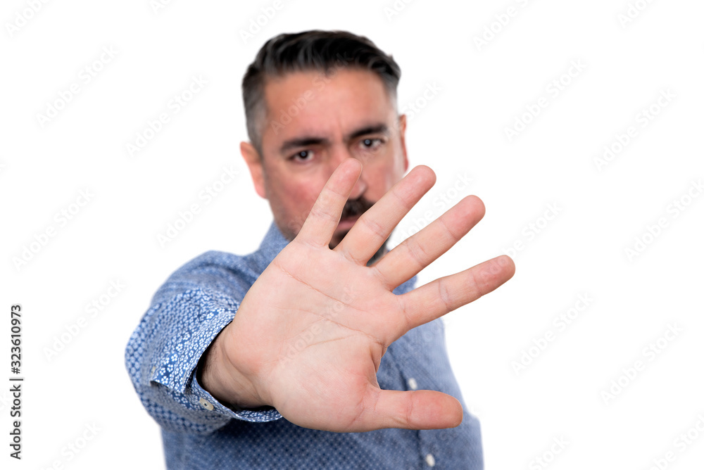 Portrait of angry man wearing blue shirt. The focus is on hand. Portrait of angry man wearing blue shirt. The focus is on hand.