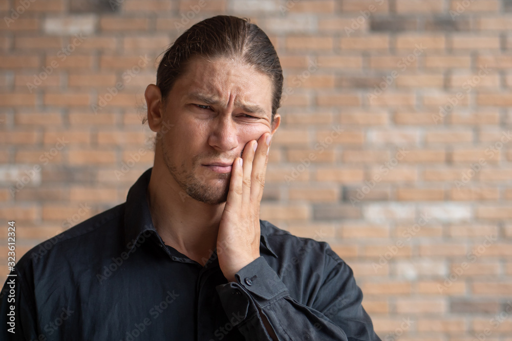 man suffers from toothache; concept of oral care, mouth hygiene, tooth decay, bruxism, grinding teeth, gingivitis, wisdom tooth extraction, tooth and gum inflammation, personal health care, body care man suffers from toothache; concept of oral care, mouth hygiene, tooth decay, bruxism, grinding teeth, gingivitis, wisdom tooth extraction, tooth and gum inflammation, personal health care, body care